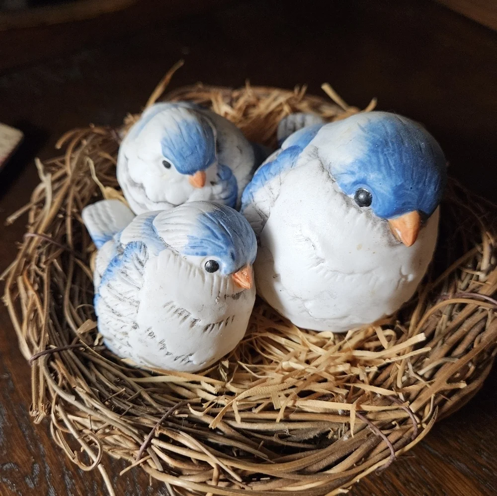 Fat blue bird mama and babies on nest figurine.